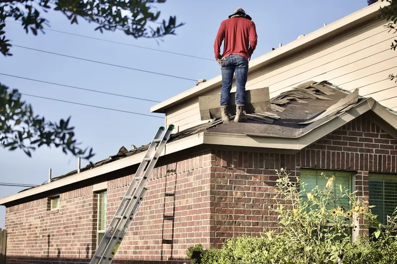 Professional roofer working on a residential roof in Greenville